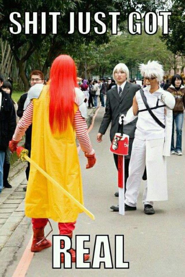 Meme image of cosplayers dressed as sword-weilding Ronald McDonald and Colonel Sanders. The Colonel's sword using a KFC bucket as a crossguard. The caption reads "Shit Just Got Real"