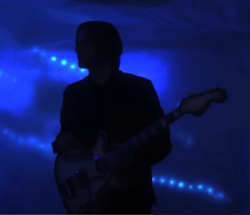 Still image from the music video of Death Cab For Cutie's song "You Are A Tourist" from 2011's "CODES and KEYS". Silhouette of Ben Gibbard with his guitar.