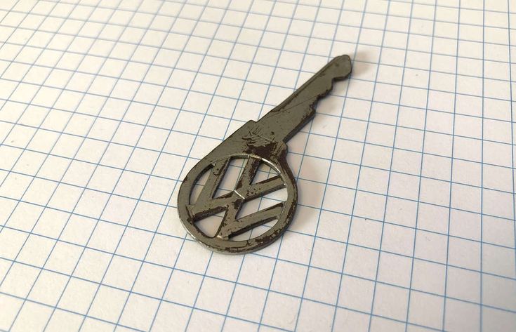 Image of a 1970 Volkswagen Standard Beetle car key. It has the VW logo incorporated into the actual key itself. A thing of beauty.