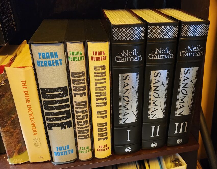 Nala's copies of The Dune Encyclopedia, the Folio Society's first 3 Dune novels, and the 3 Volumes of the The Sandman Omnibus